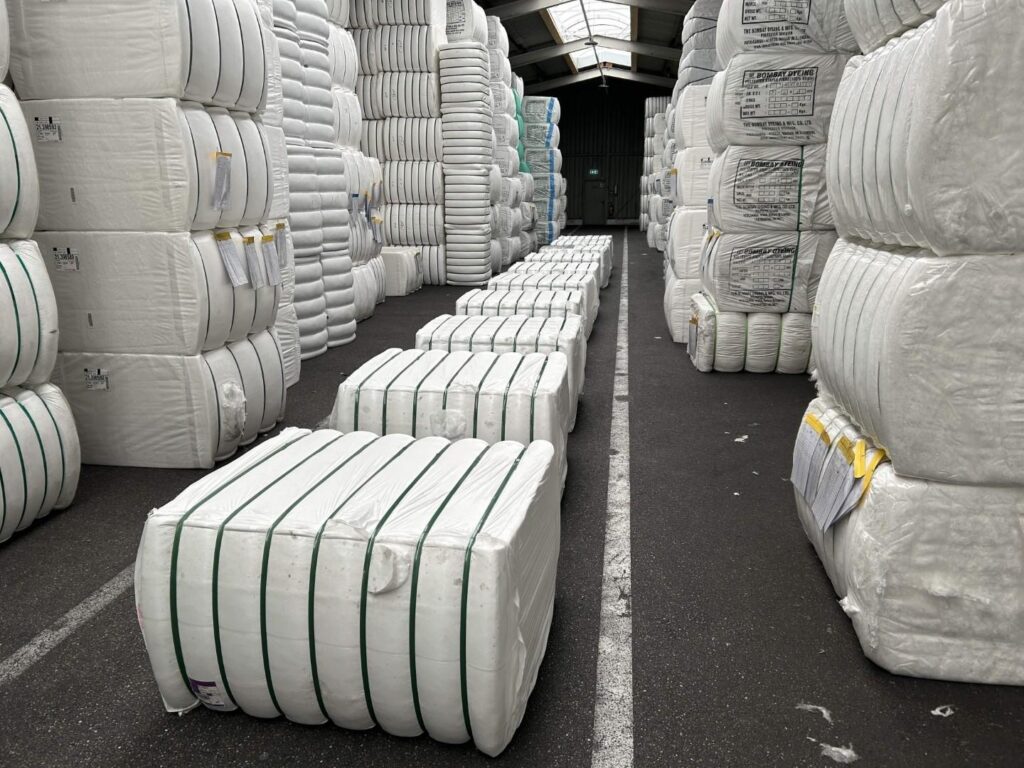Compressed recycled polyester staple fiber bale packaging and strapping